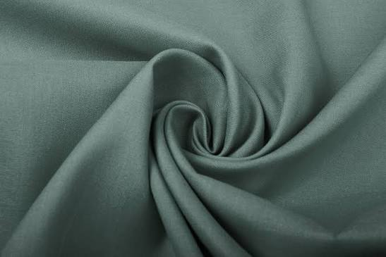 Sage green fabric arranged in a spiral with a fine surface texture and soft folds