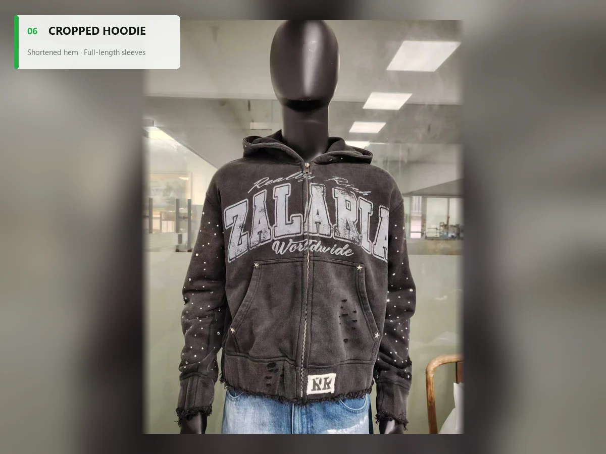 Washed charcoal cropped zip hoodie with a short distressed hem and studded sleeves