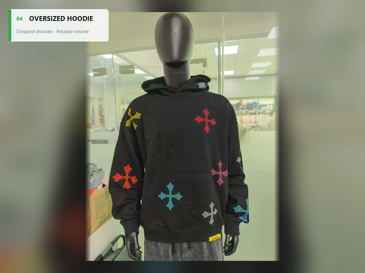 Black oversized pullover hoodie with dropped shoulders and colorful rhinestone motifs